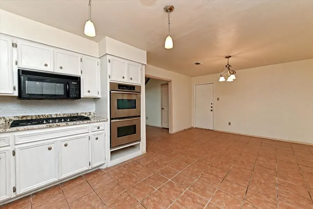 a kitchen with stainless steel appliances a stove a microwave and a refrigerator
