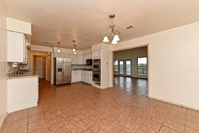a view of a kitchen with a sink and a refrigerator
