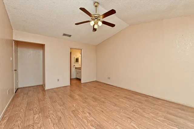 an empty room with fan and a ceiling fan