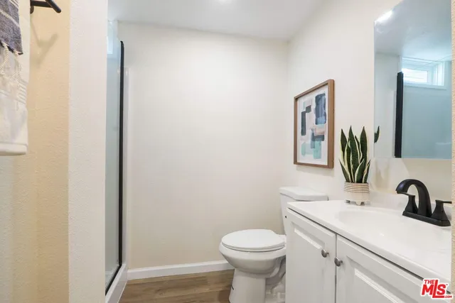 a bathroom with a sink a toilet and mirror