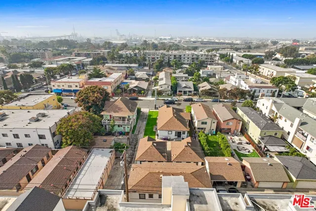 an aerial view of residential building with green space