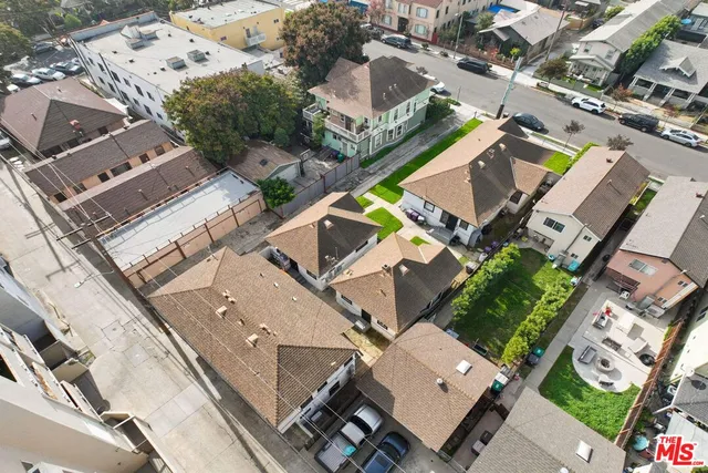 an aerial view of a house with a mountain