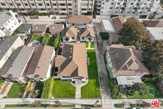 an aerial view of residential houses with outdoor space and street view