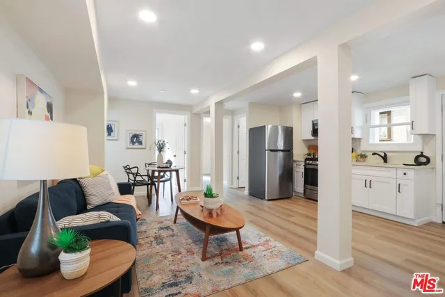 a living room with furniture and kitchen view
