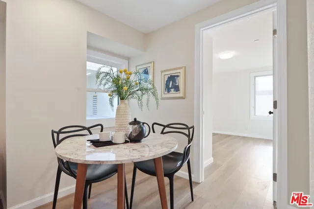a view of a dining room with furniture and front door