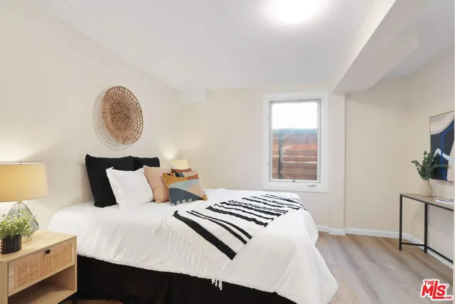 a bedroom with a bed and a potted plant