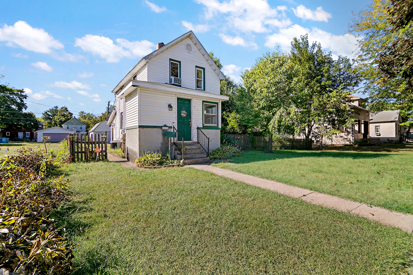 1179 South 4th Avenue Kankakee, IL 60901 - Photo 1 of 18 a view of a yard in front of a house with a big yard