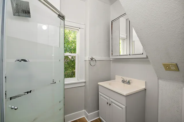 a bathroom with a glass shower door