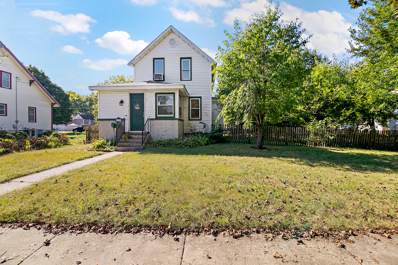 1179 South 4th Avenue Kankakee, IL 60901 - Photo 2 of 18 a view of a white house with a yard