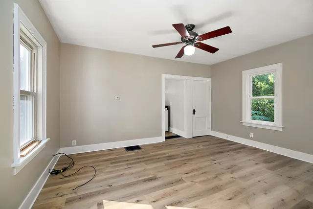 a view of a livingroom with a ceiling fan and window