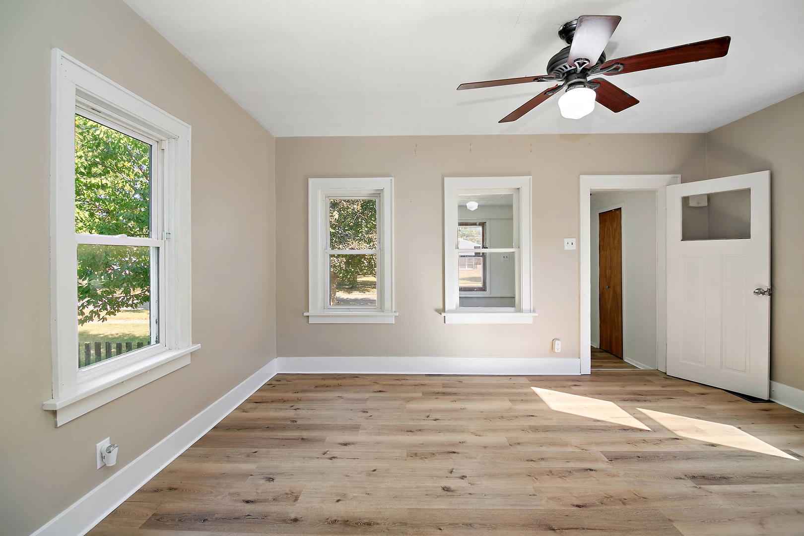 1179 South 4th Avenue Kankakee, IL 60901 - Photo 7 of 18 a view of an empty room with wooden floor and a window
