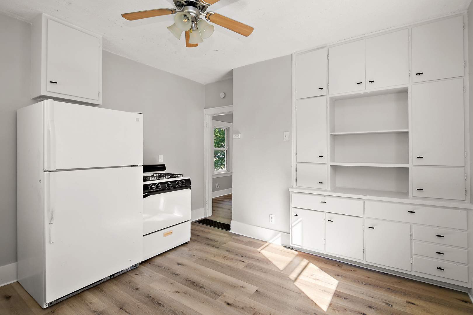 1179 South 4th Avenue Kankakee, IL 60901 - Photo 8 of 18 a kitchen with cabinets a refrigerator and a stove