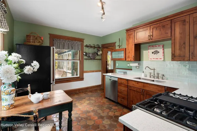 a dining room with furniture a rug and a large window