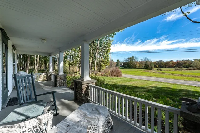 a view of balcony with furniture and garden