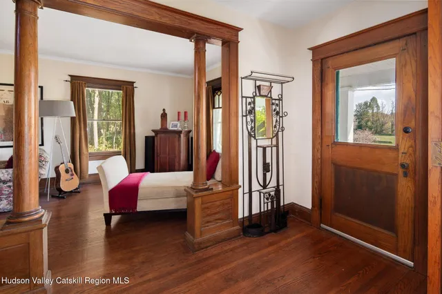 a living room with furniture and wooden floor