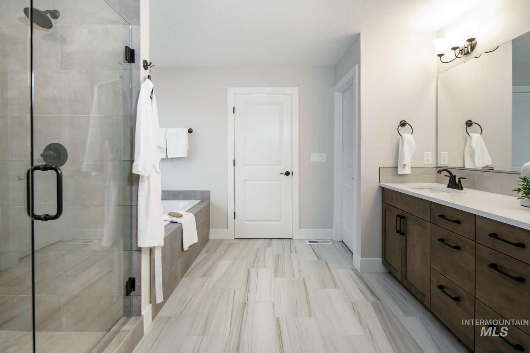 1009 West Malbar Street Meridian, ID 83646 - Photo 9 of 10 Bathroom featuring vanity, a shower stall, and a garden tub