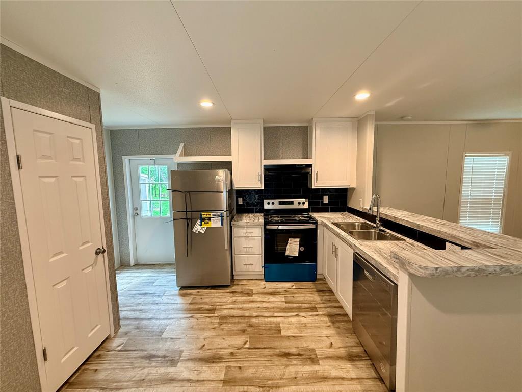 3193 Timberwild Street Wills Point, TX 75169 - Photo 4 of 13 a kitchen with a refrigerator a stove and a sink