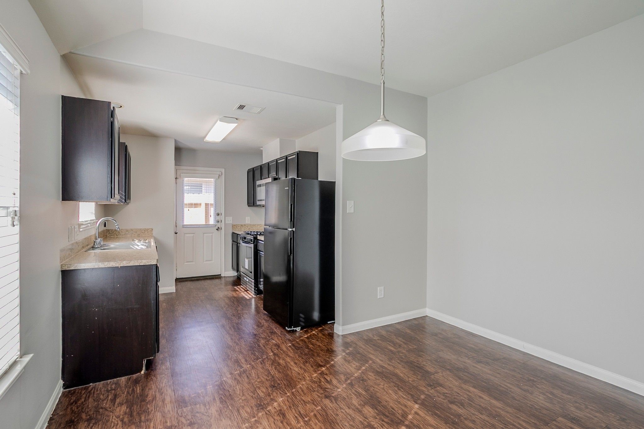 21431 Ryans Path Lane Houston, TX 77073 - Photo 15 of 38 a view of a kitchen with a refrigerator and a wooden floor