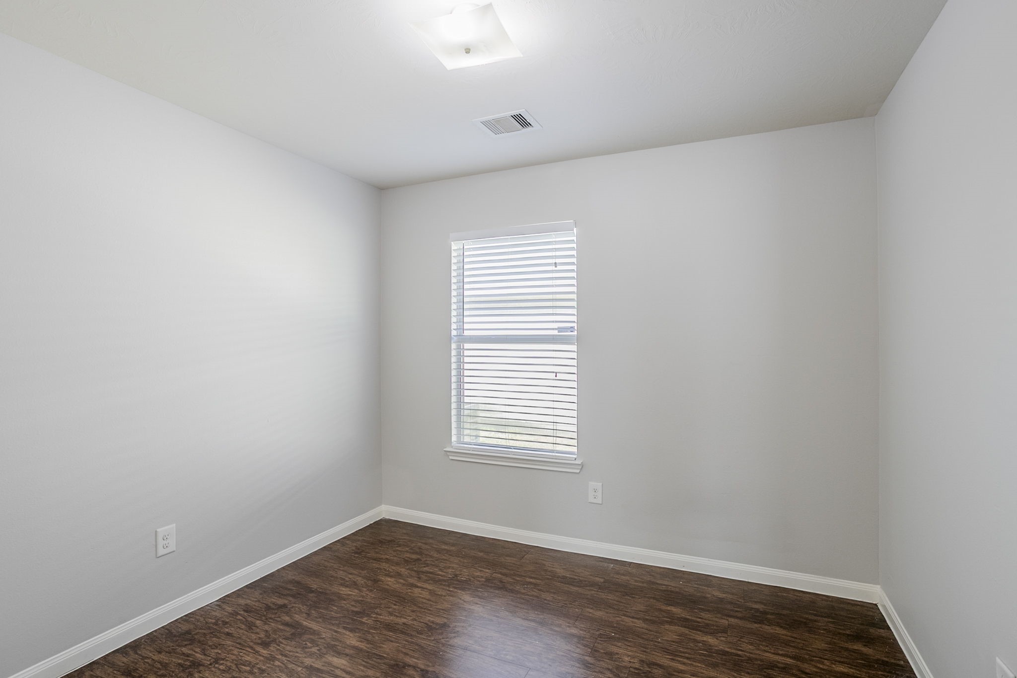 21431 Ryans Path Lane Houston, TX 77073 - Photo 25 of 38 an empty room with wooden floor and windows