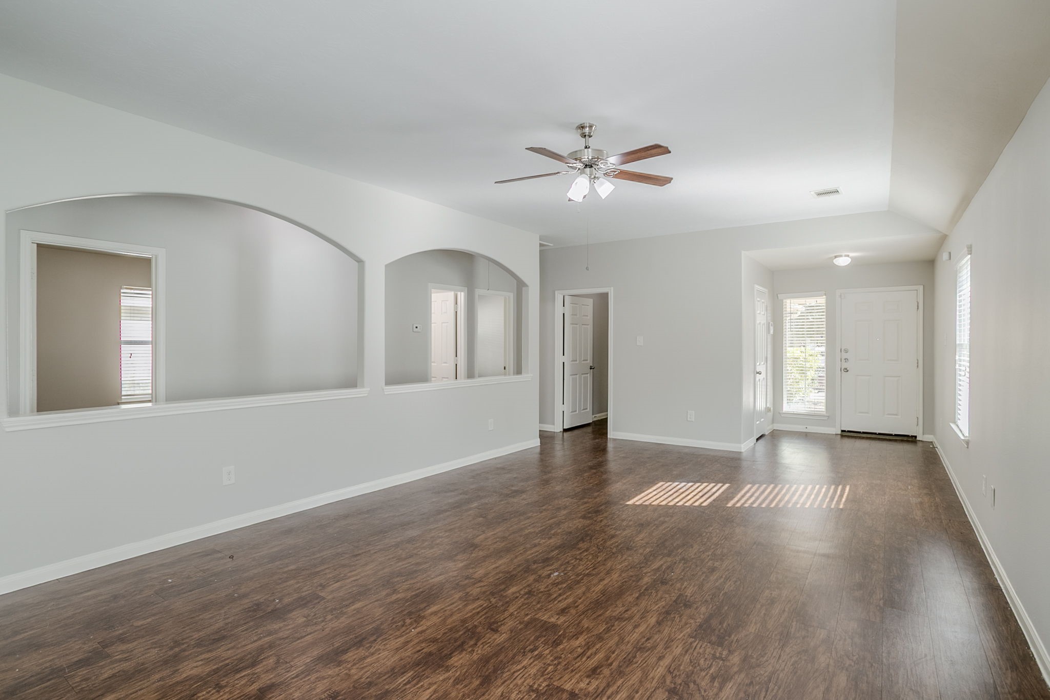 21431 Ryans Path Lane Houston, TX 77073 - Photo 10 of 38 a view of an empty room with wooden floor and a ceiling fan