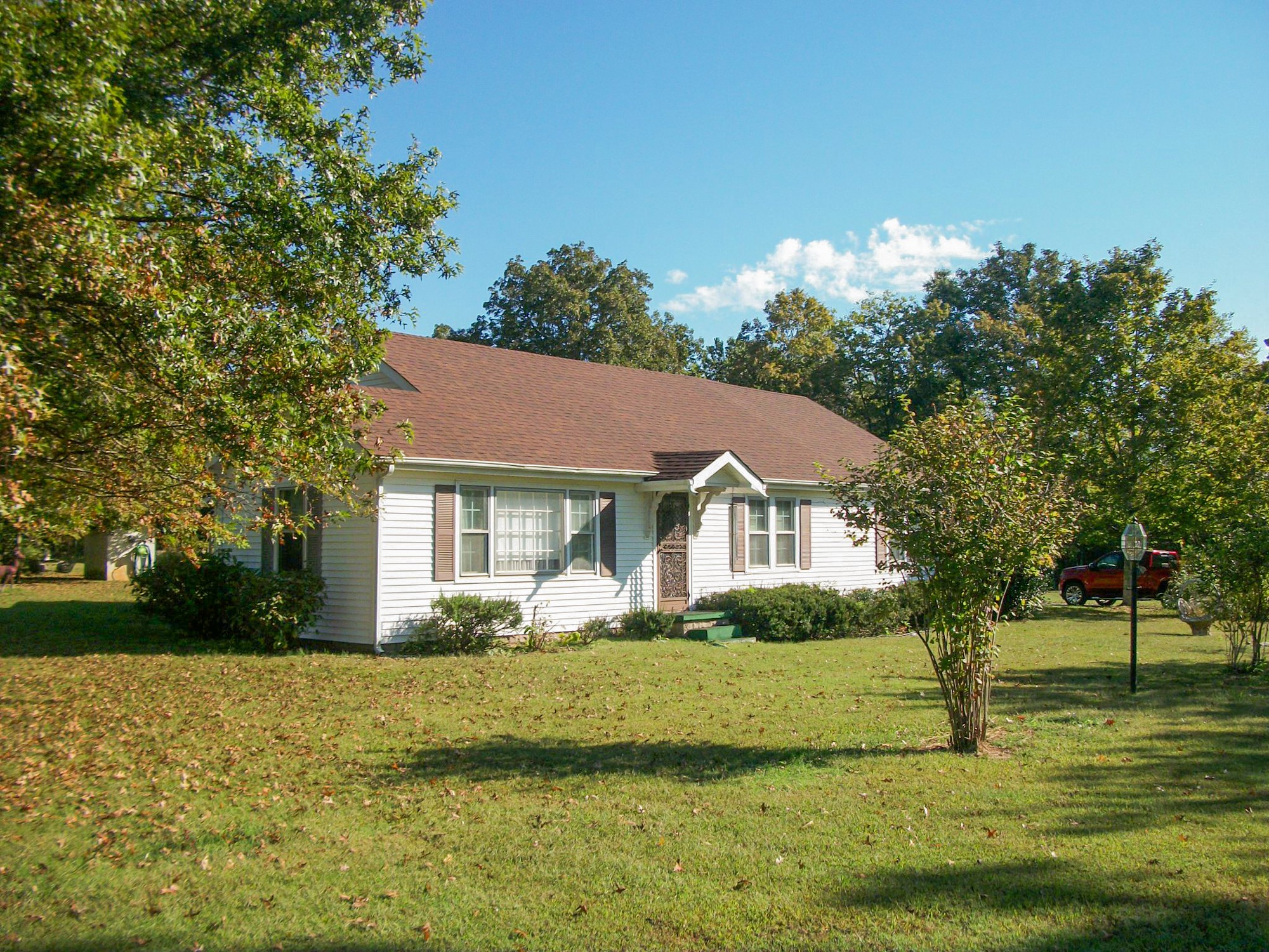 9670 Panther Creek Road Christiana, TN 37037 - Photo 16 of 16 a front view of a house with a garden
