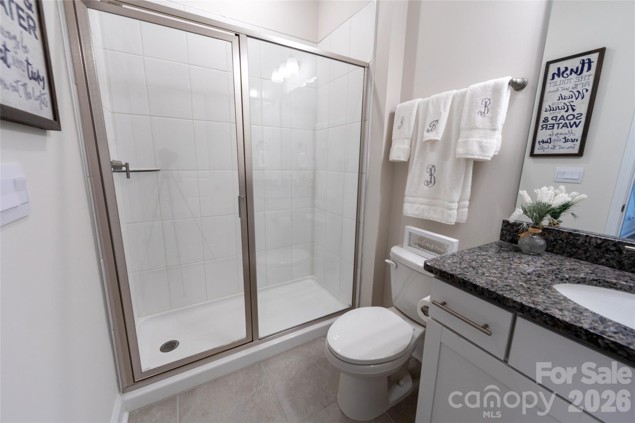 151 Aviendha Lane Troutman, NC 28166 - Photo 18 of 43 a bathroom with a granite countertop sink toilet and shower