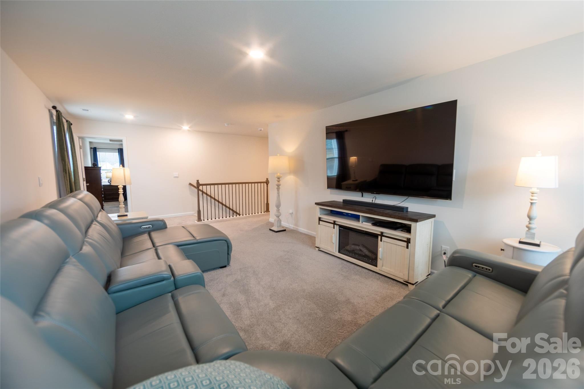 151 Aviendha Lane Troutman, NC 28166 - Photo 21 of 43 a living room with furniture and a flat screen tv