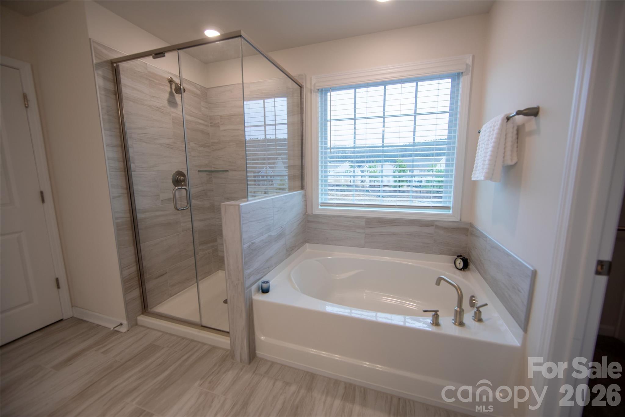151 Aviendha Lane Troutman, NC 28166 - Photo 25 of 43 a bathroom with a bathtub and shower