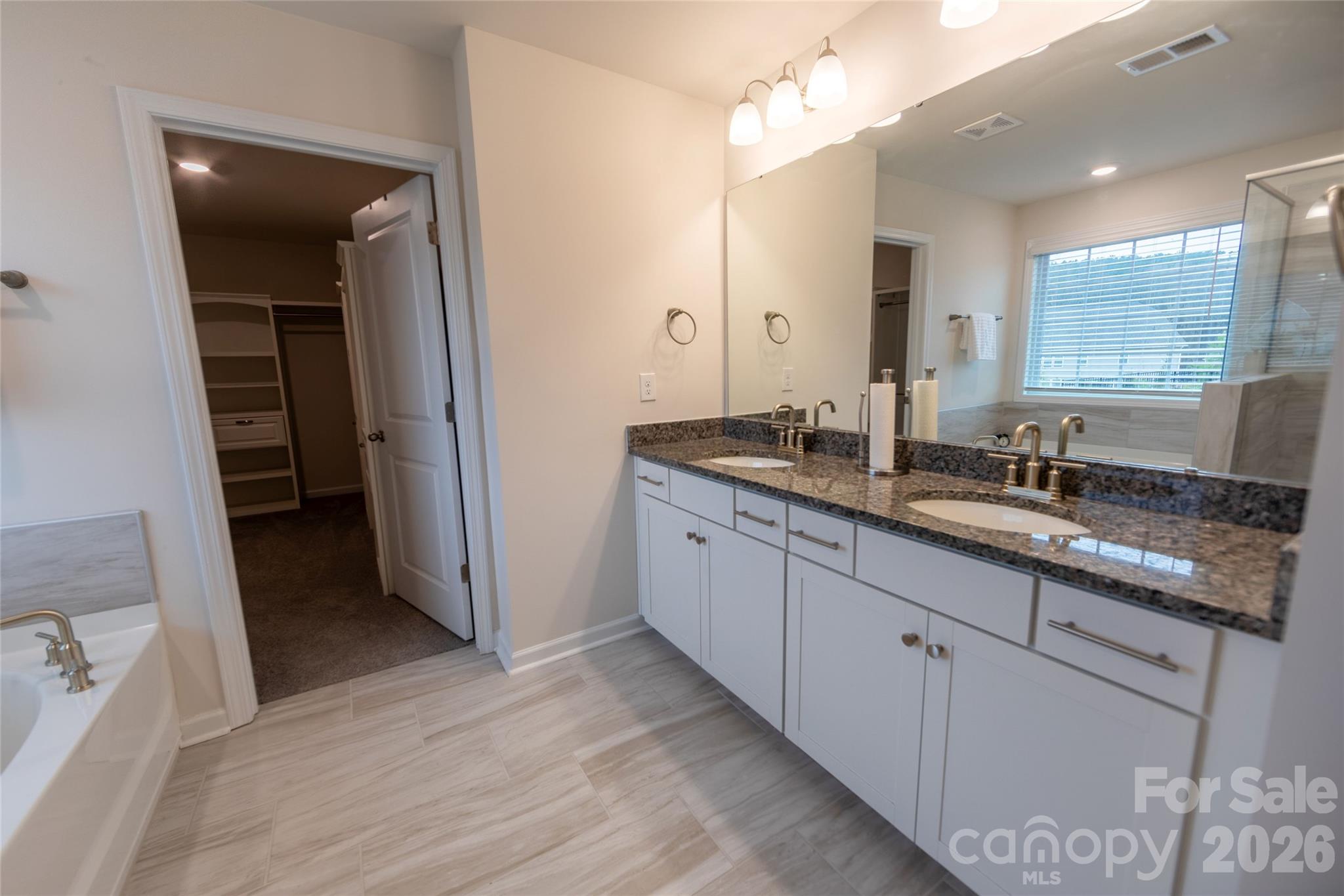 151 Aviendha Lane Troutman, NC 28166 - Photo 26 of 43 a bathroom with a double vanity sink and mirror