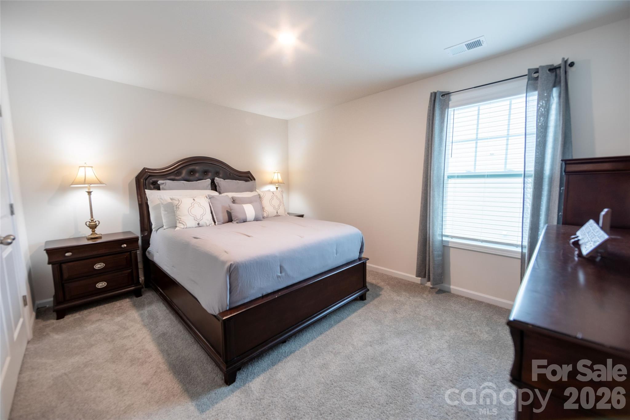 151 Aviendha Lane Troutman, NC 28166 - Photo 28 of 43 a bedroom with a bed and a window