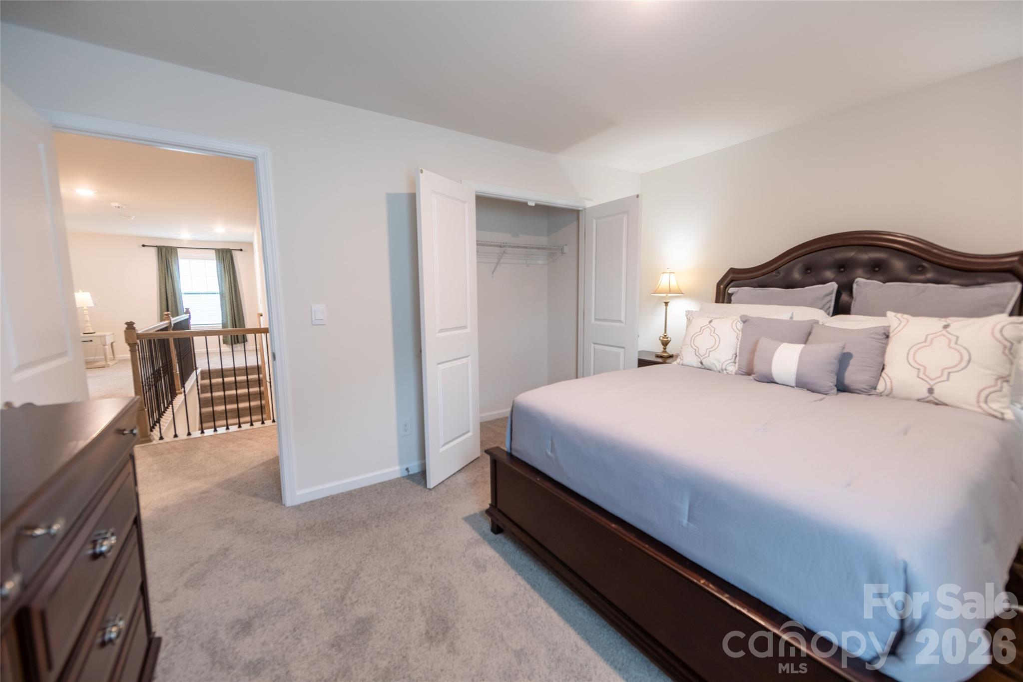 151 Aviendha Lane Troutman, NC 28166 - Photo 29 of 43 a bedroom with a bed and a mirror
