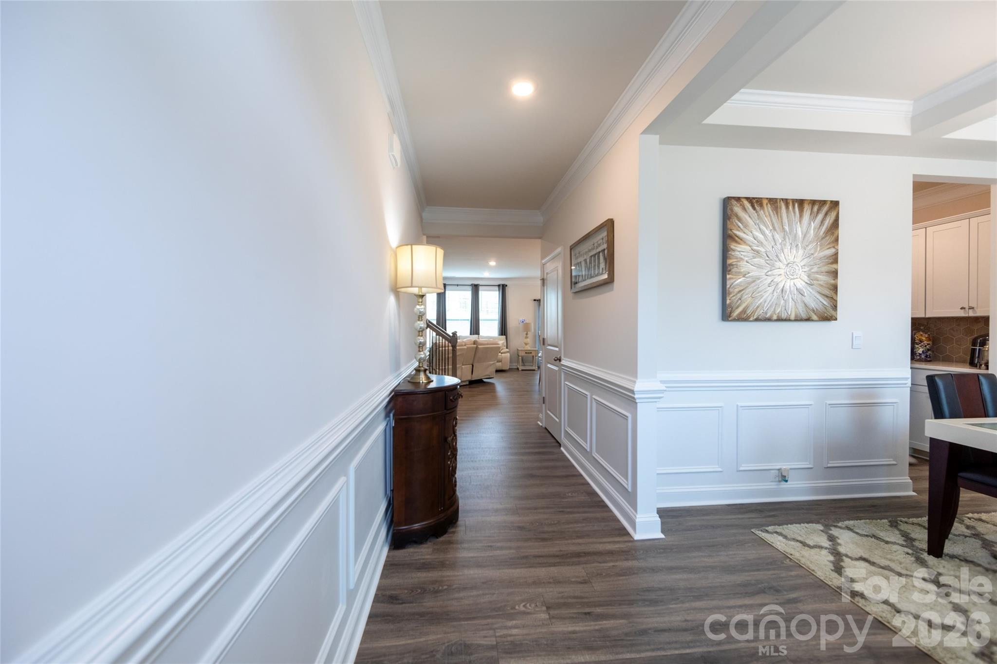151 Aviendha Lane Troutman, NC 28166 - Photo 5 of 43 a hallway with a wooden floor and a living room