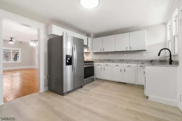 a kitchen with stainless steel appliances granite countertop a refrigerator and a sink