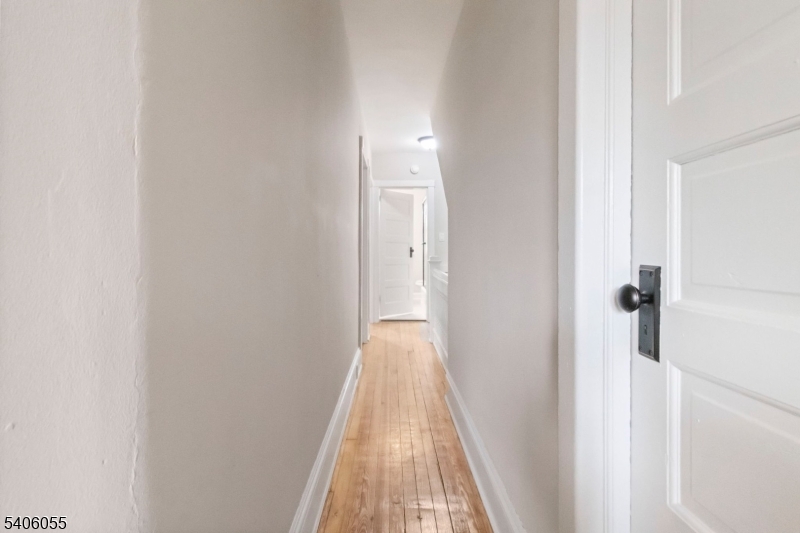 233 Irwin Street Phillipsburg, NJ 08865 - Photo 12 of 33 a view of a hallway with wooden floor and a bathroom