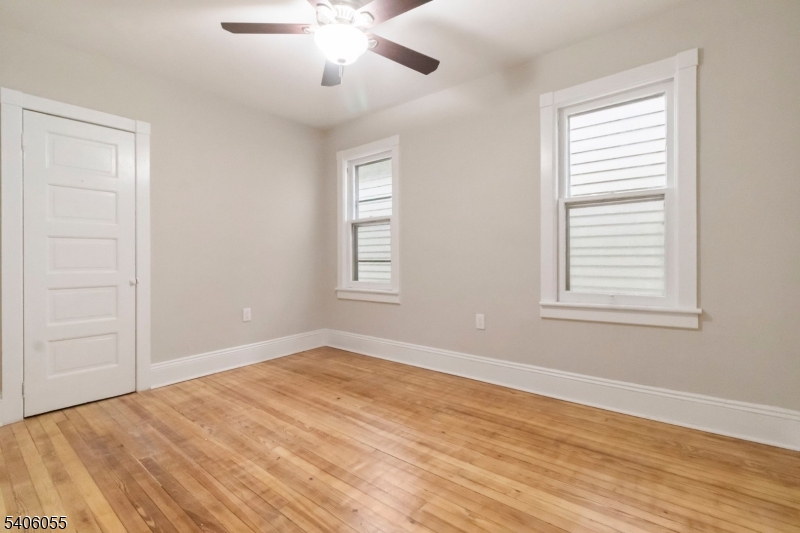 233 Irwin Street Phillipsburg, NJ 08865 - Photo 15 of 33 a view of empty room with wooden floor and fan