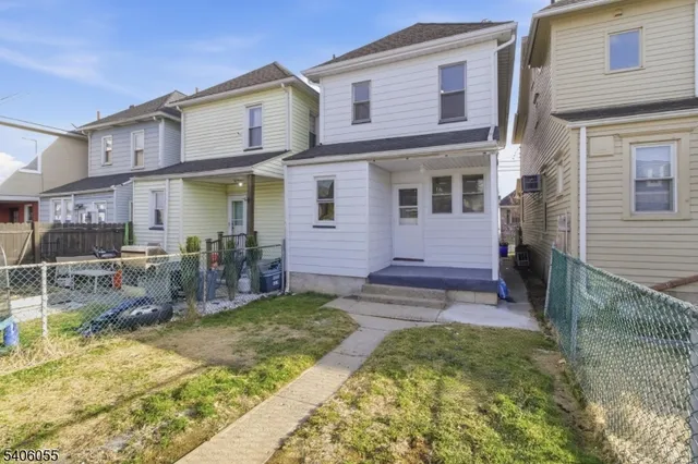 a view of a house with a yard and sitting area
