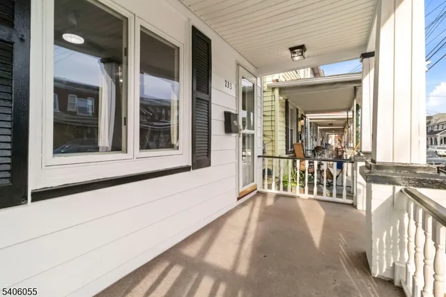 a view of a porch with a table and chairs