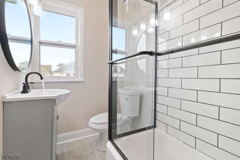 233 Irwin Street Phillipsburg, NJ 08865 - Photo 6 of 33 a bathroom with a sink and mirror with shower