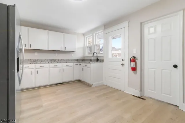 a kitchen with cabinets a sink and a window