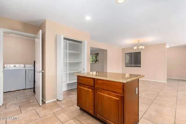 an empty room with a window and ceiling fan