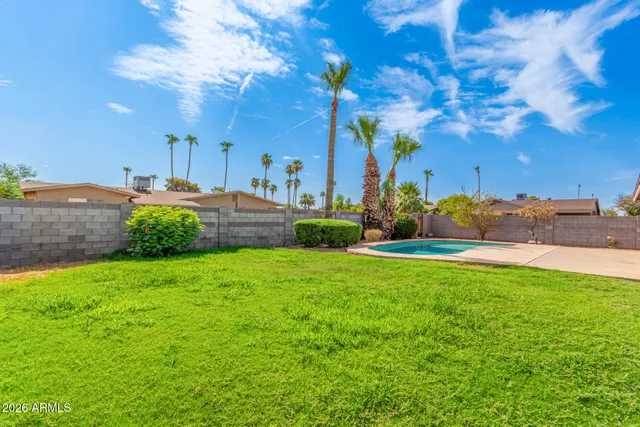 a view of a swimming pool with a yard