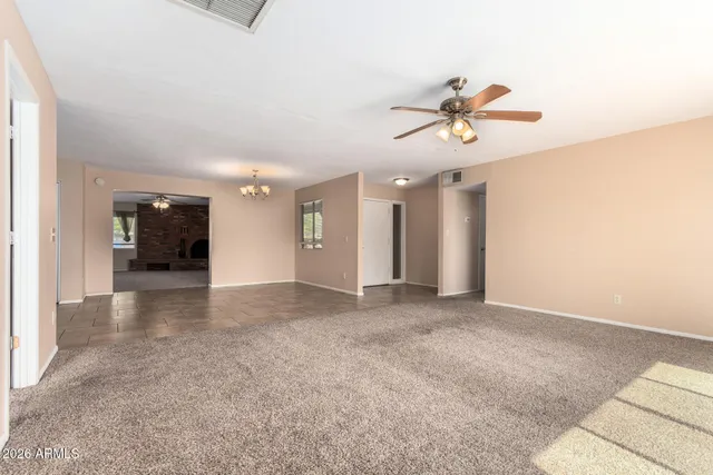a view of a livingroom with a ceiling fan and window