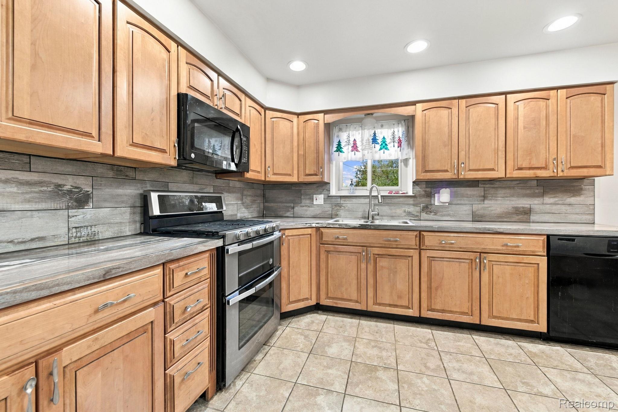 13265 12 Mile Road Warren, MI 48088 - Photo 17 of 33 Kitchen featuring wood cabinetry, a stainless steel double oven range, and a built-in microwave