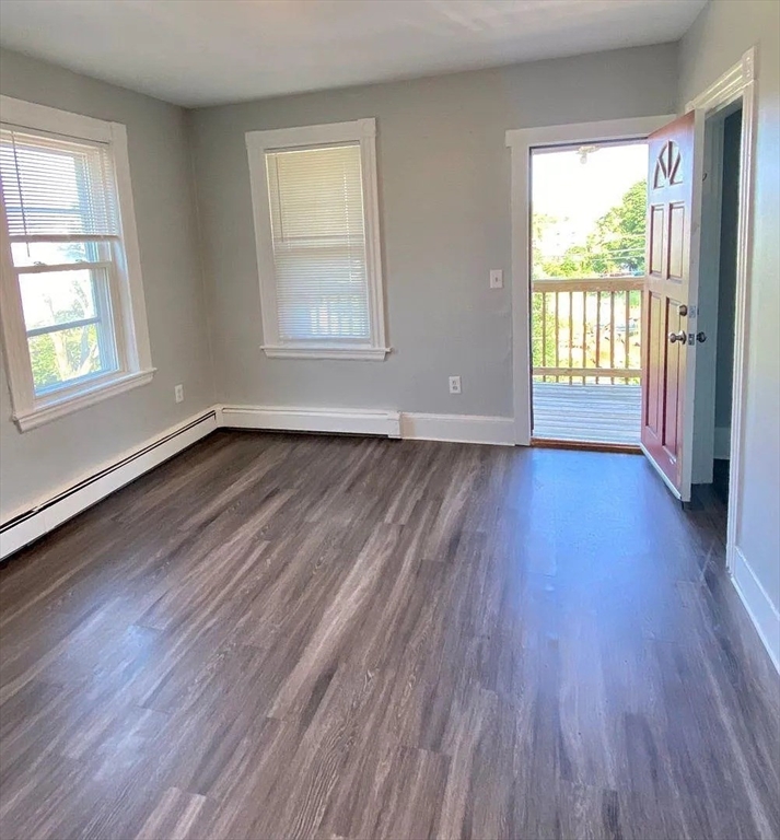15 Shurtleff Street Chelsea, MA 02150 - Photo 5 of 9 an empty room with wooden floor and windows