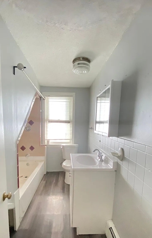 15 Shurtleff Street Chelsea, MA 02150 - Photo 6 of 9 a bathroom with a tub sink and mirror