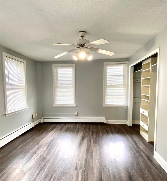 15 Shurtleff Street Chelsea, MA 02150 - Photo 7 of 9 an empty room with wooden floor and windows