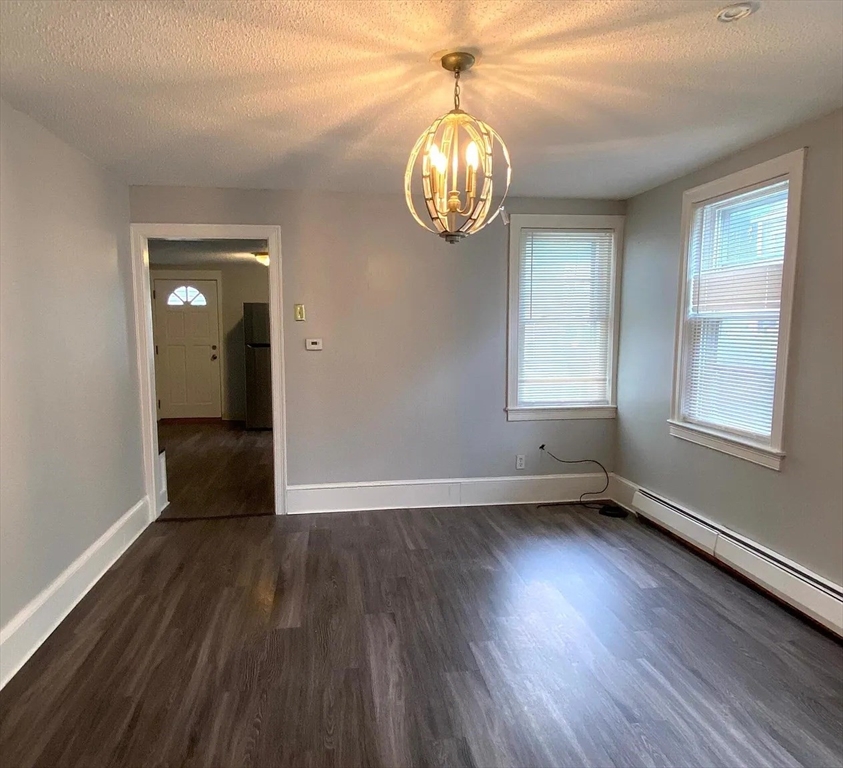 15 Shurtleff Street Chelsea, MA 02150 - Photo 8 of 9 a view of empty room with wooden floor and fan