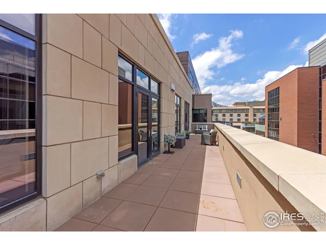 a bedroom with a bed and large windows