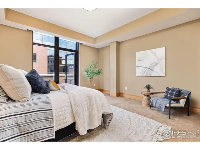 a spacious bedroom with a bed and a large window