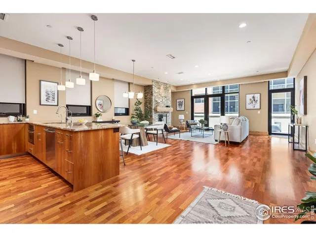 a living room with stainless steel appliances kitchen island granite countertop wooden floors and view living room